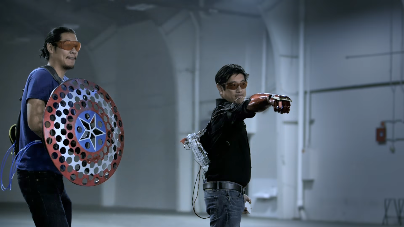 Allen Pan and grant Umehara are holding recreations of comic book weapons they made. Allen is holding a Captain America flying shield drone, and Grant is holding a Iron Man laser arm.